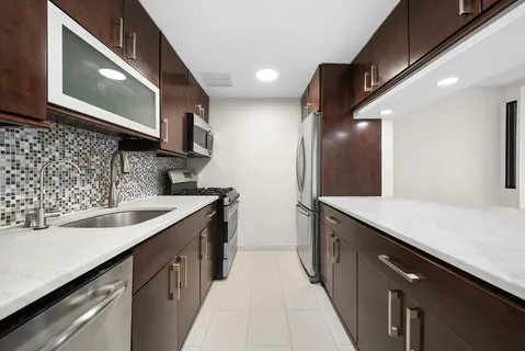 a kitchen with a sink and a refrigerator