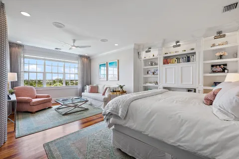 a bedroom with a bed couch and a window