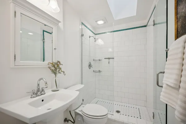 a bathroom with a sink toilet and shower