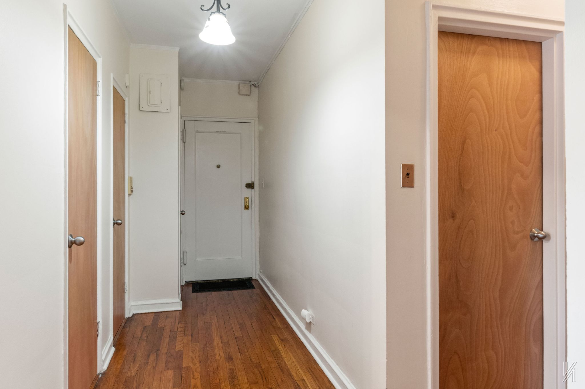 22-08 76th Street, Unit D2 Queens, NY 11370 - Photo 16 of 20 a view of a hallway with wooden floor
