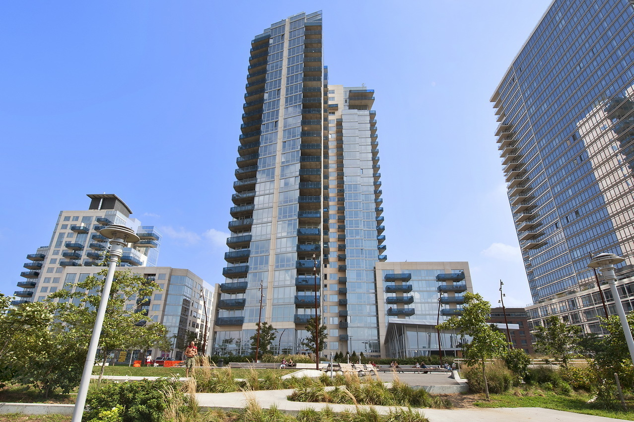 22 North 6th Street, Unit 5C Brooklyn, NY 11249 - Photo 18 of 19 a front view of multi story residential apartment building with yard and parking space