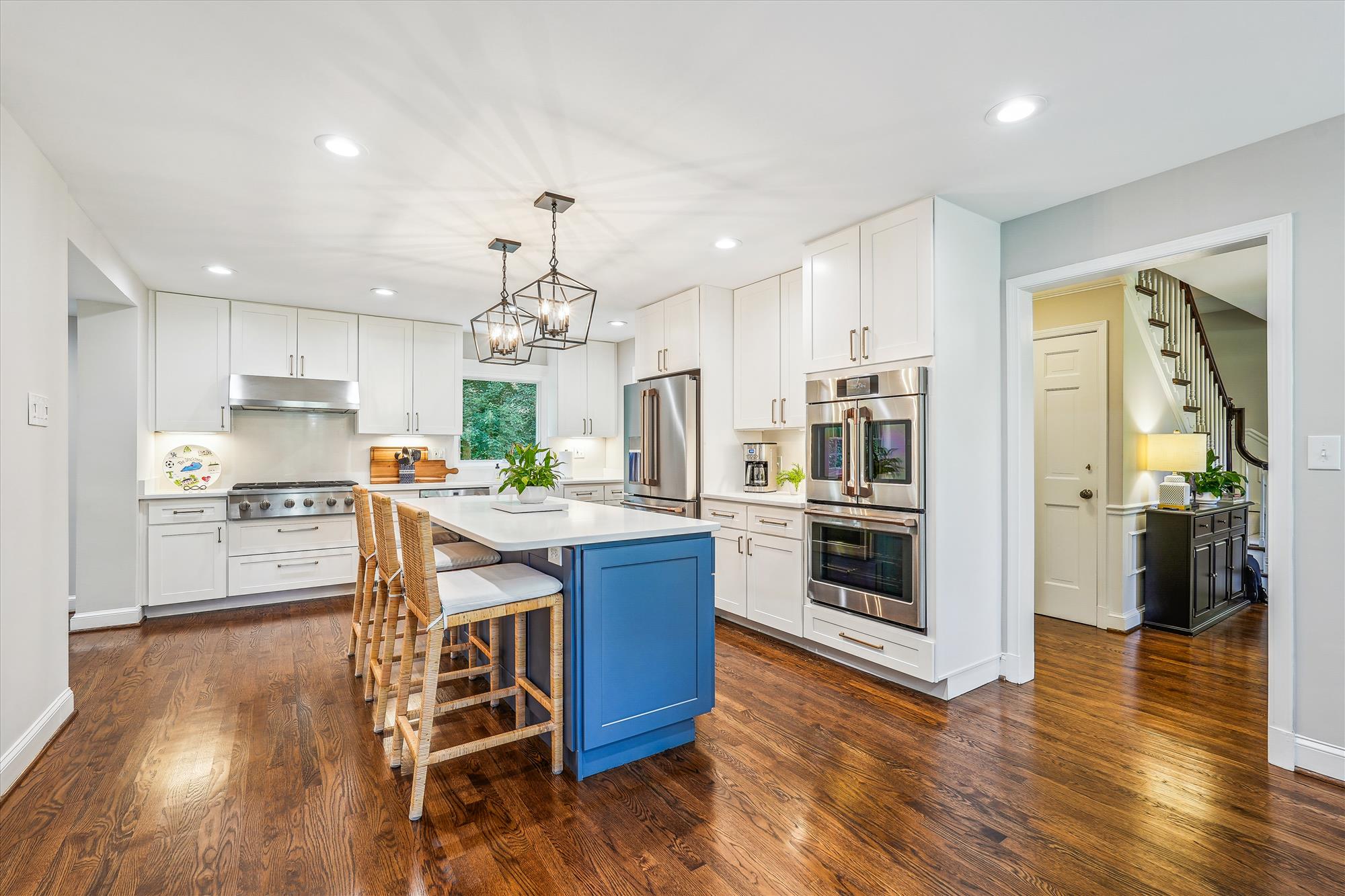9904 Carter Road Bethesda, MD 20817 - Photo 13 of 41 a kitchen with stainless steel appliances granite countertop wooden floors and white cabinets