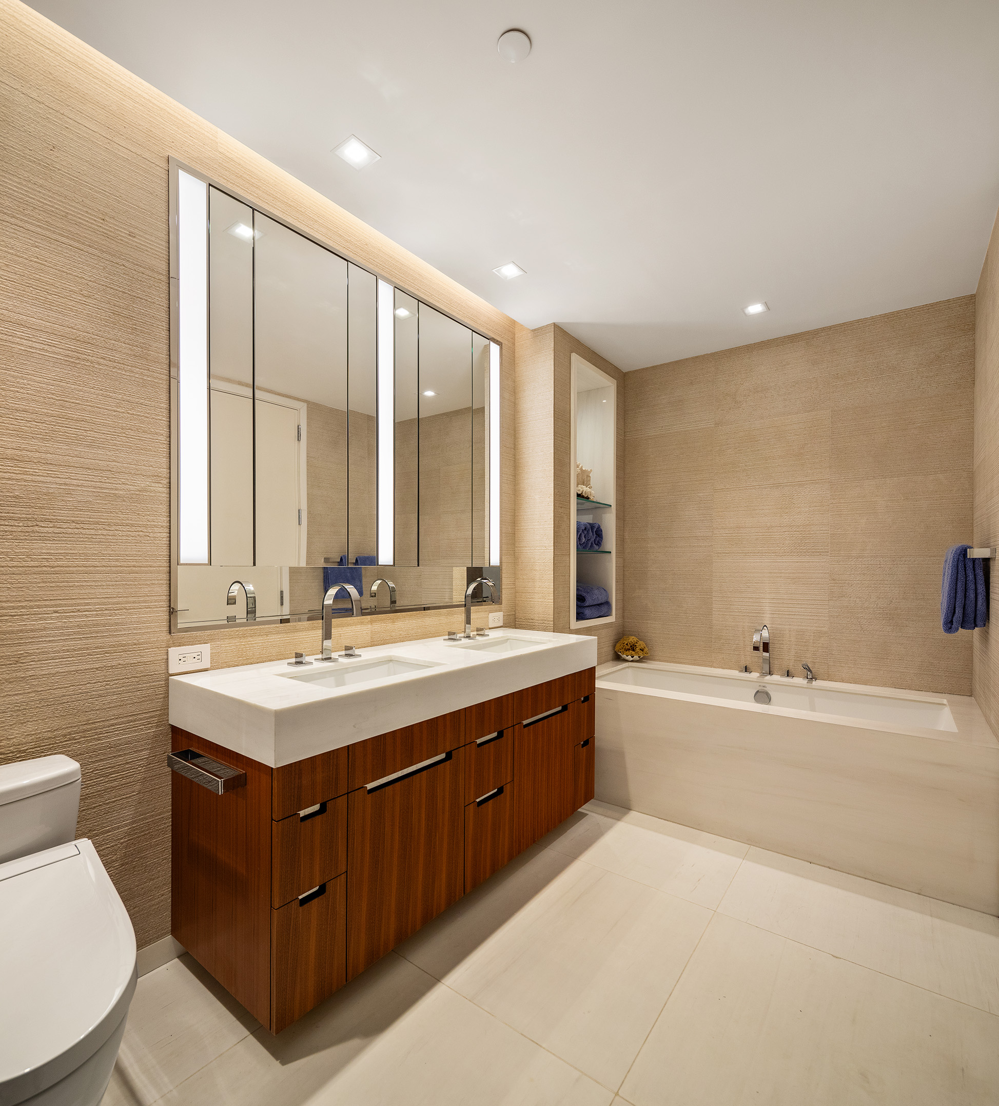 1 West End Avenue, Unit 22E Manhattan, NY 10023 - Photo 7 of 32 a bathroom with a tub sink toilet and mirror