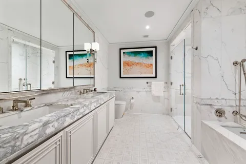 a bathroom with a granite countertop sink mirror and a bathtub