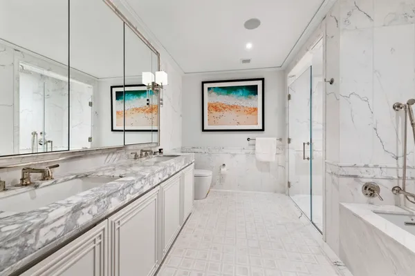 a bathroom with a granite countertop sink mirror and a bathtub