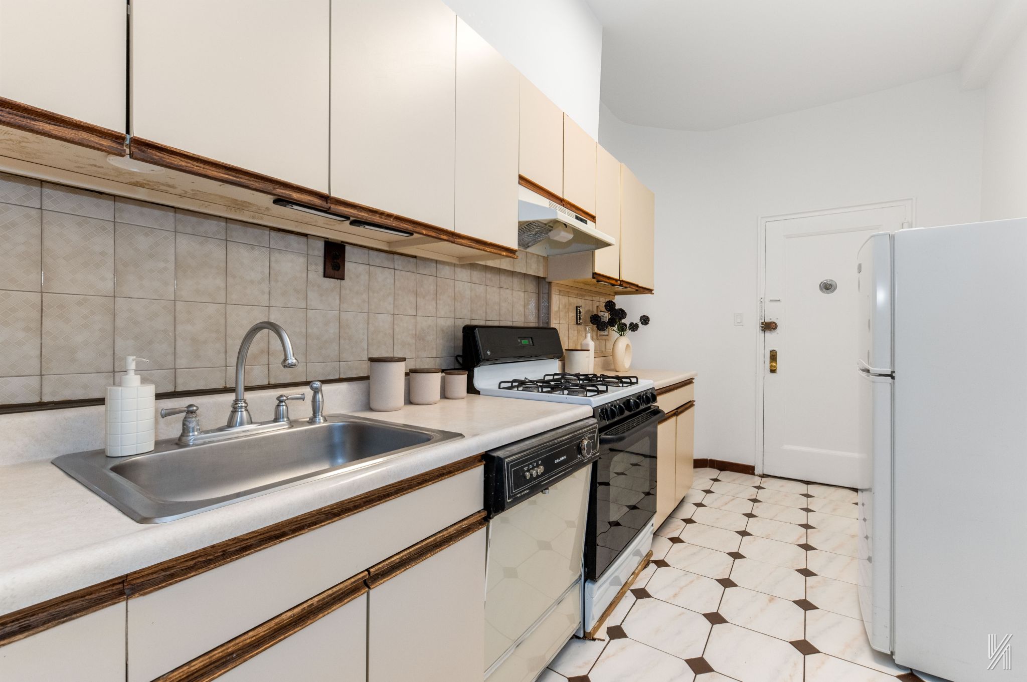39-30 52nd Street, Unit GA Queens, NY 11377 - Photo 6 of 15 a kitchen with sink a stove and cabinets