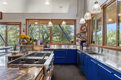 a kitchen with stainless steel appliances kitchen island granite countertop a sink and cabinets