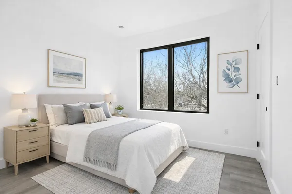 a bedroom with a large bed and a window