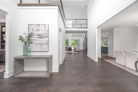 a view of a livingroom with furniture staircase and a kitchen