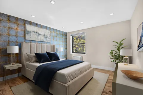 a bedroom with bed and a potted plant