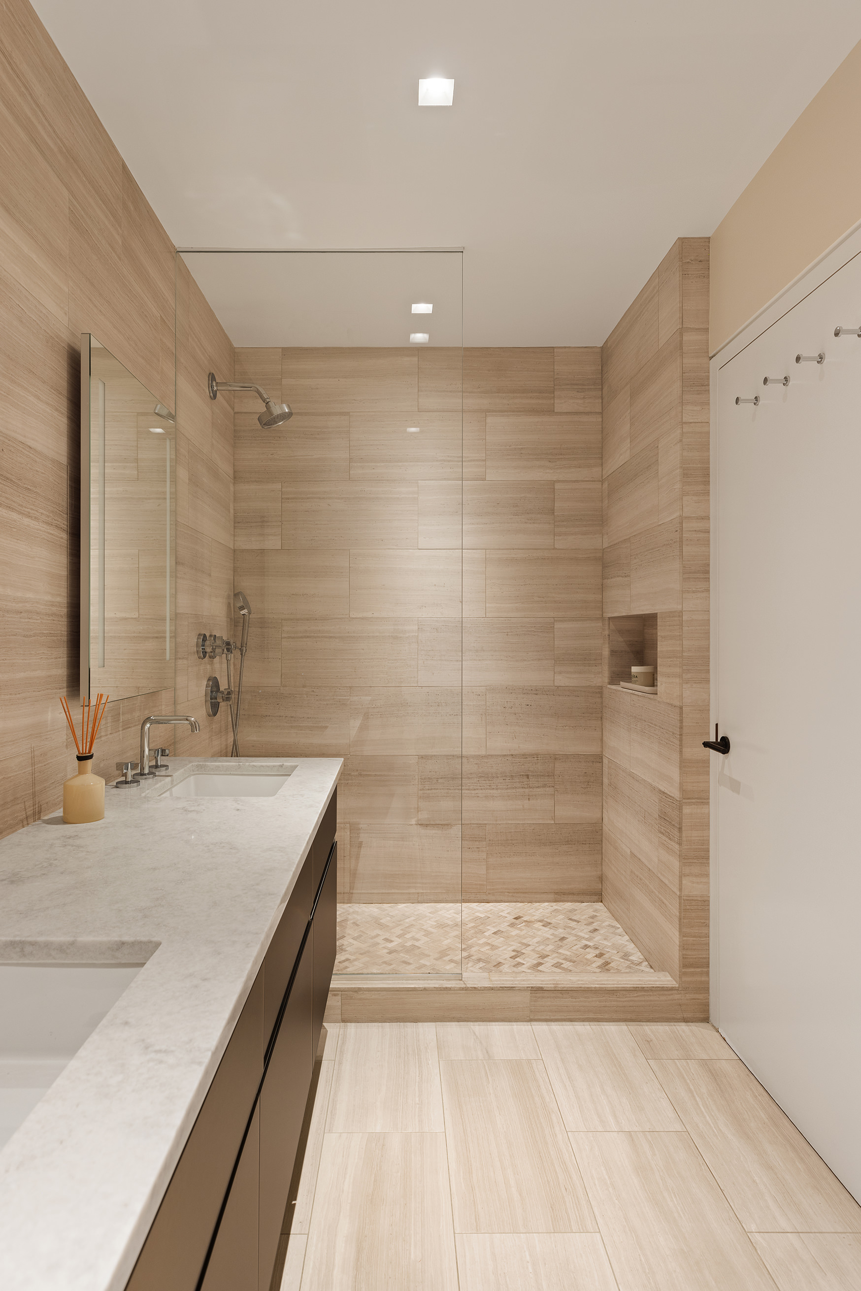 129 West 20th Street, Unit 4B Manhattan, NY 10011 - Photo 10 of 16 a bathroom with a granite countertop bathtub a sink and shower