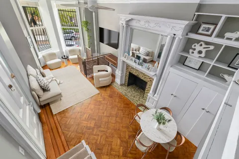 a living room with furniture and a fireplace