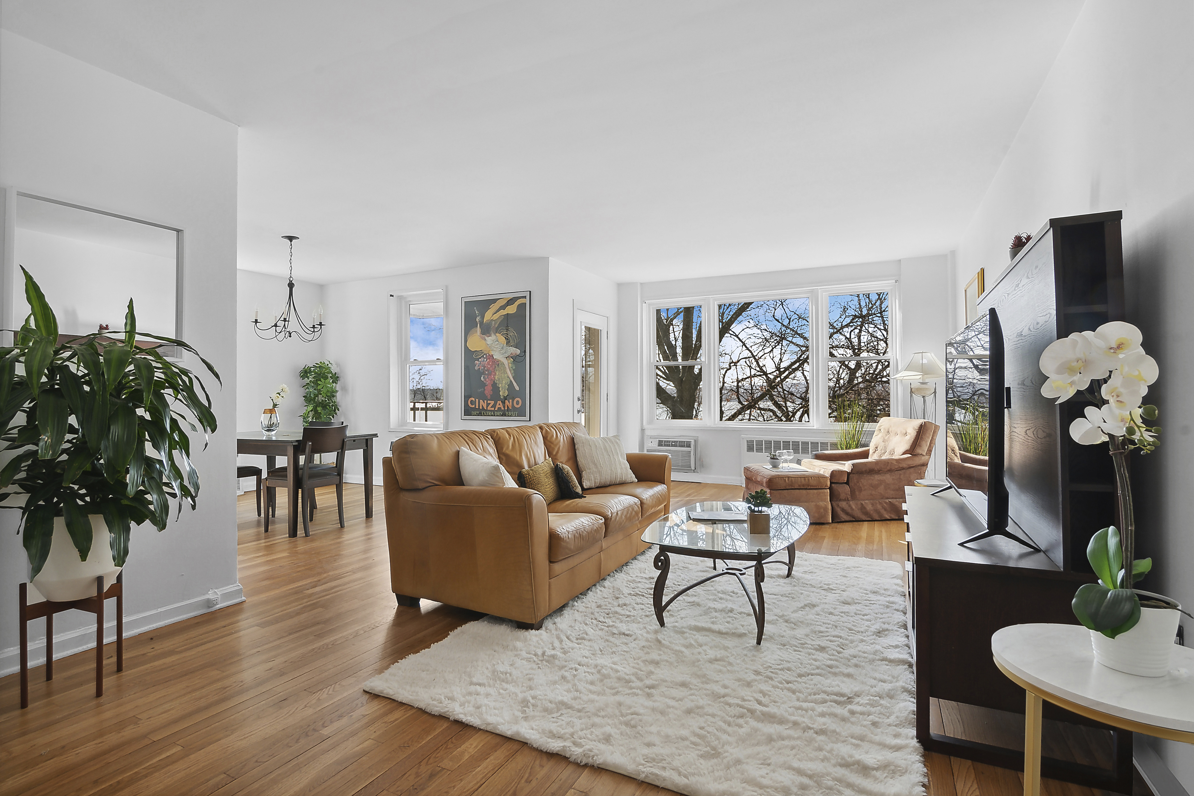 9201 Shore Road, Unit B301 Brooklyn, NY 11209 - Photo 2 of 12 a living room with furniture potted plant and a large window