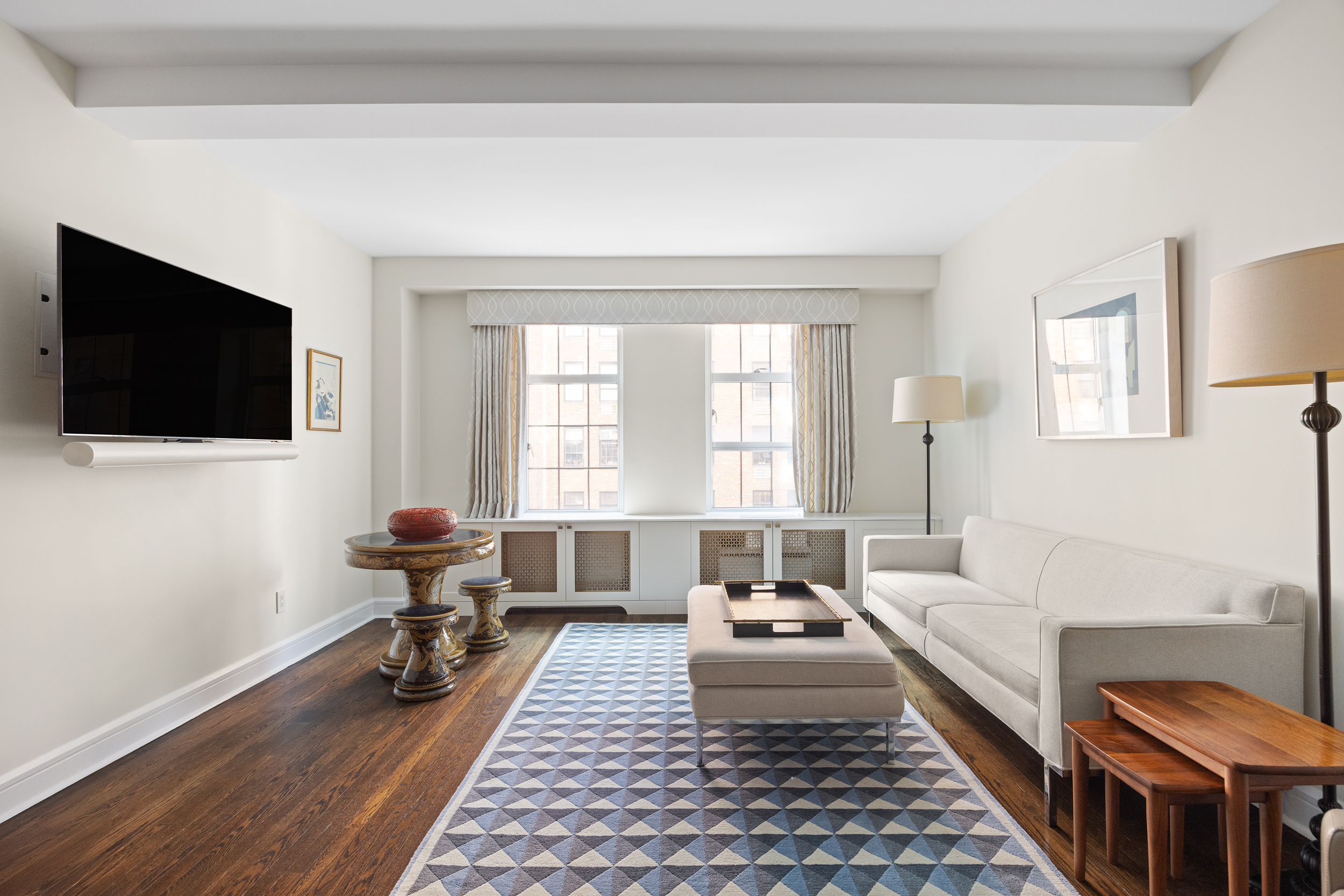 470 West 24th Street, Unit 9J Manhattan, NY 10011 - Photo 3 of 13 a living room with furniture and a flat screen tv