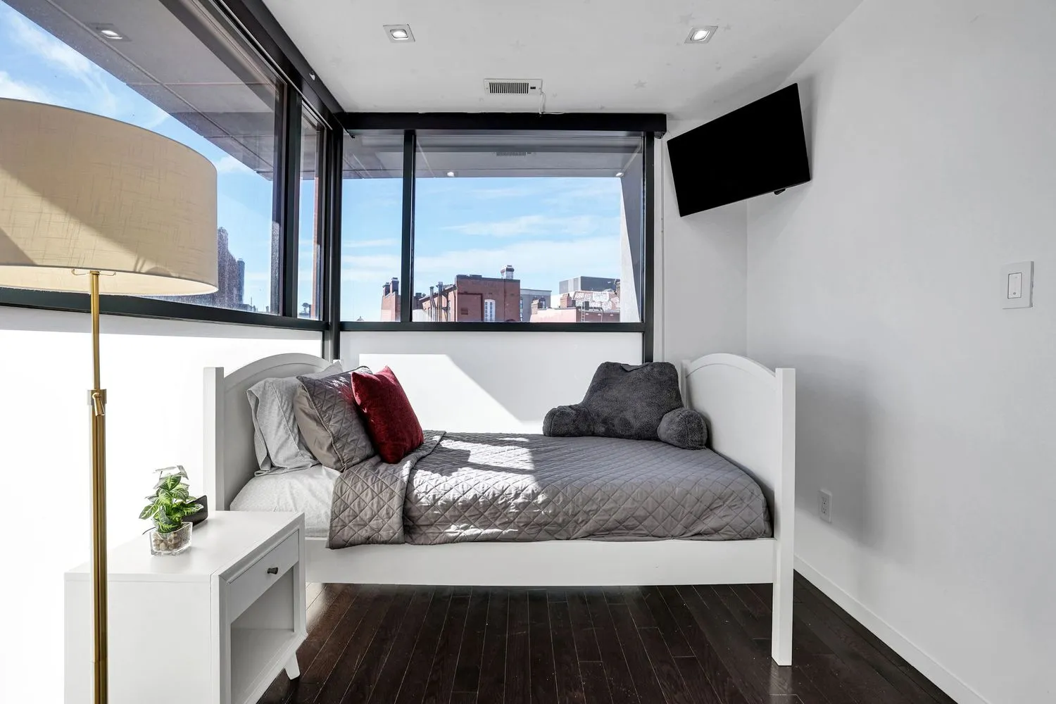 a bedroom with a bed and glass window