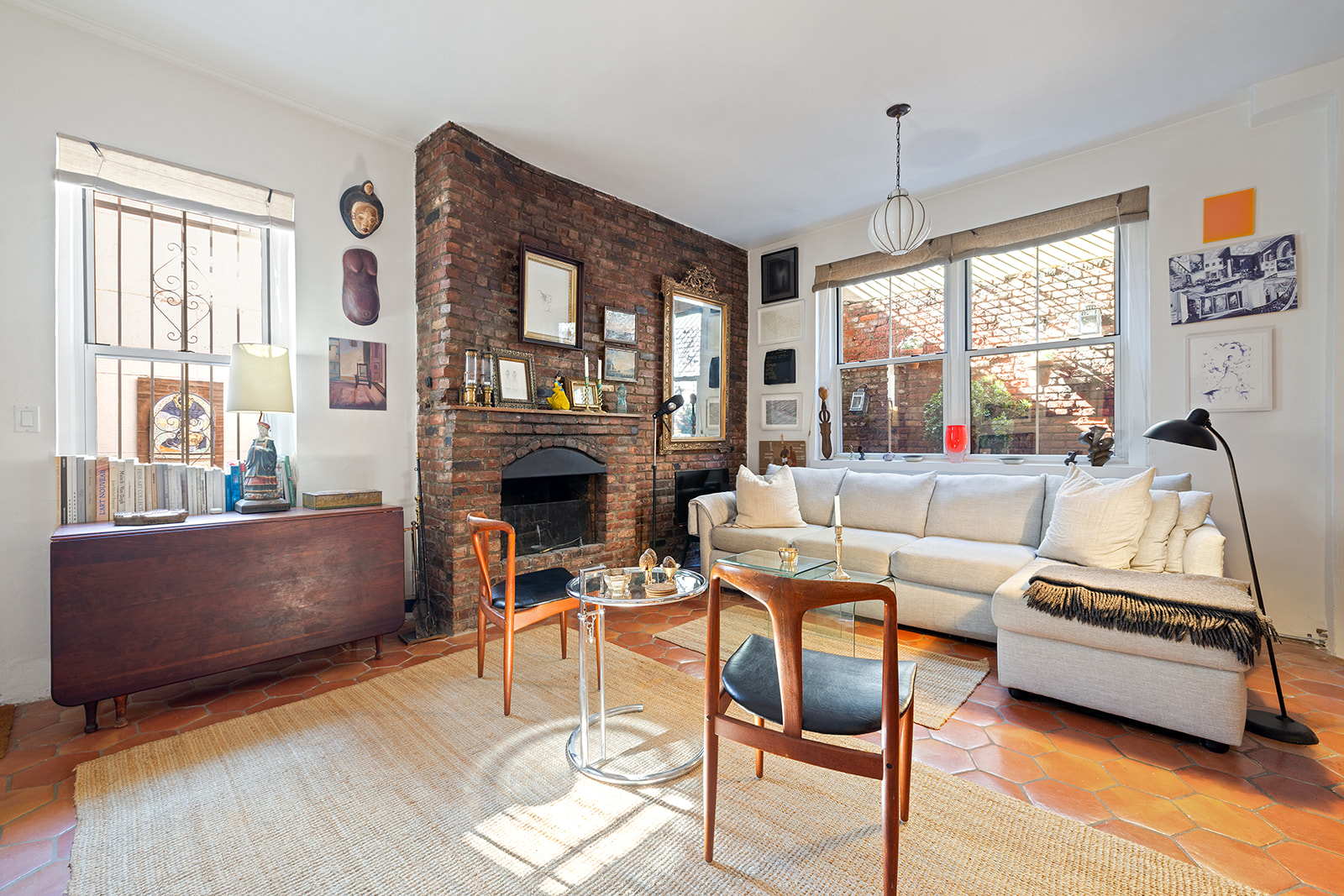 a living room with furniture a large window and a fireplace