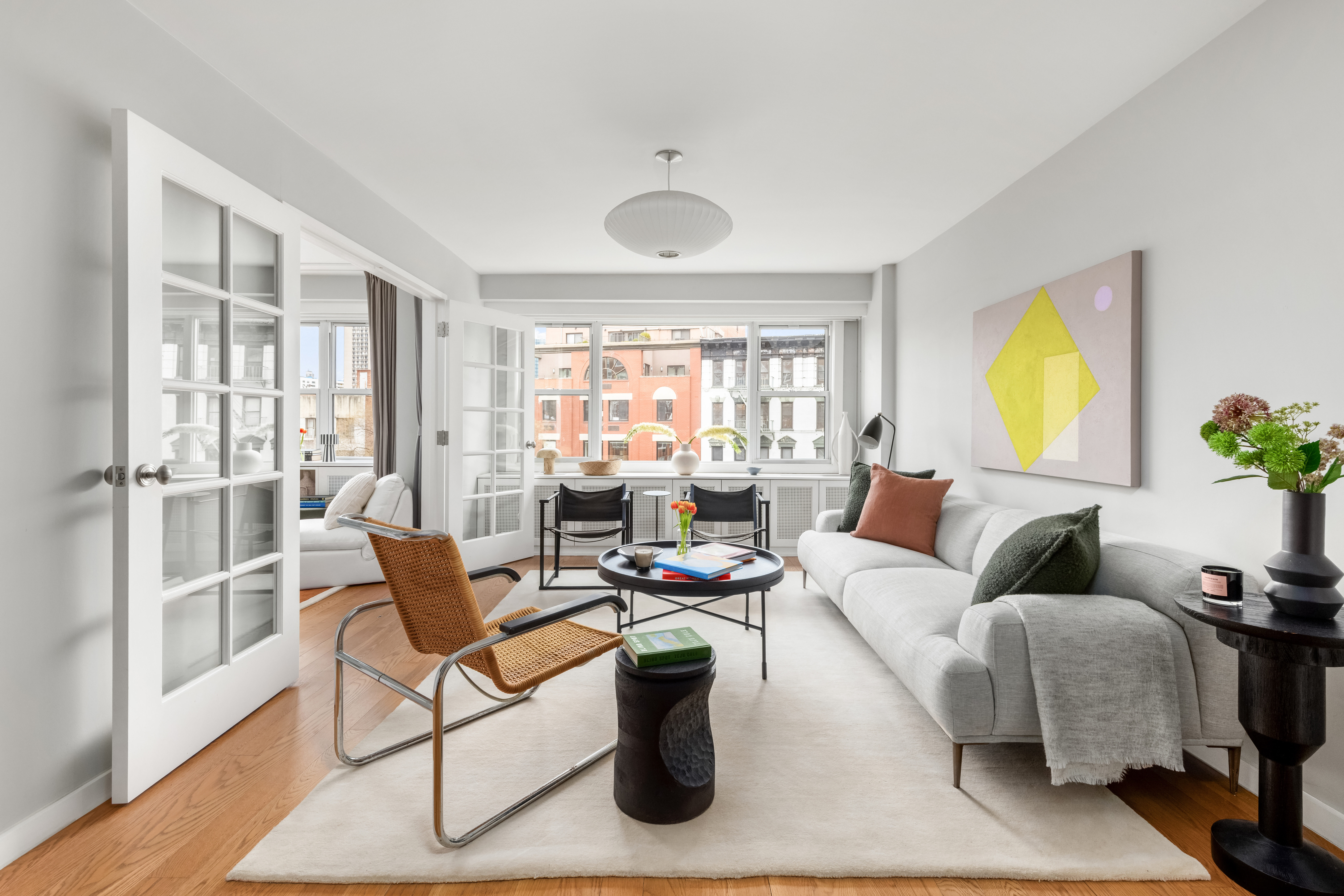 2 Charlton Street, Unit 7J Manhattan, NY 10014 - Photo 3 of 15 a living room with furniture and a large window