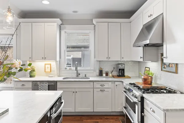 a kitchen with stainless steel appliances a sink a stove and a refrigerator
