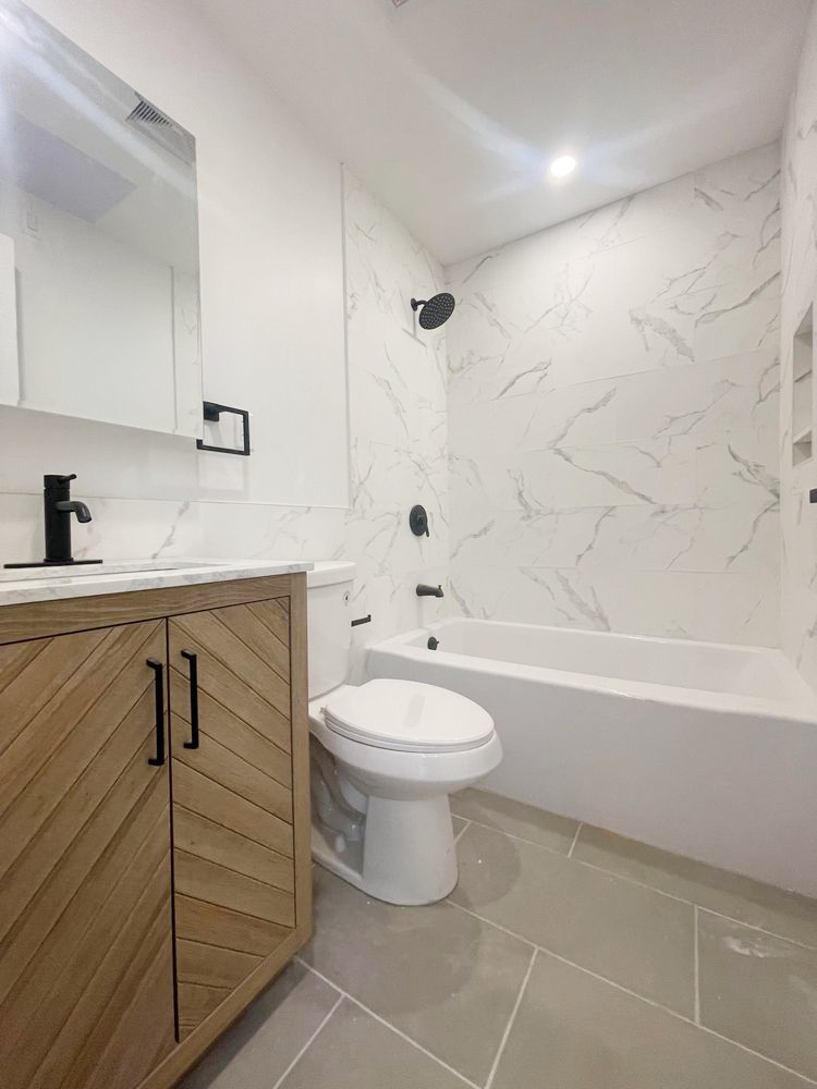 297 3rd Avenue, Unit 2 Brooklyn, NY 11215 - Photo 5 of 5 a bathroom with a toilet a sink and bathtub