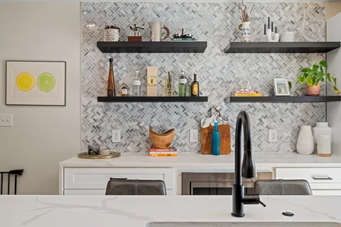 a kitchen with stainless steel appliances white cabinets and a stove