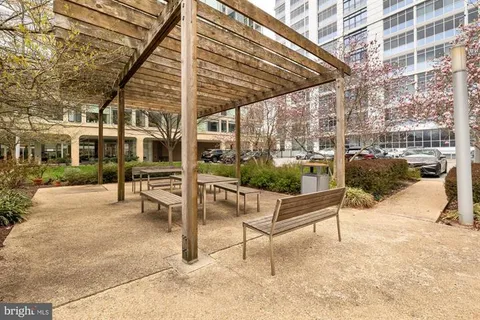 a view of a patio with a table and chairs
