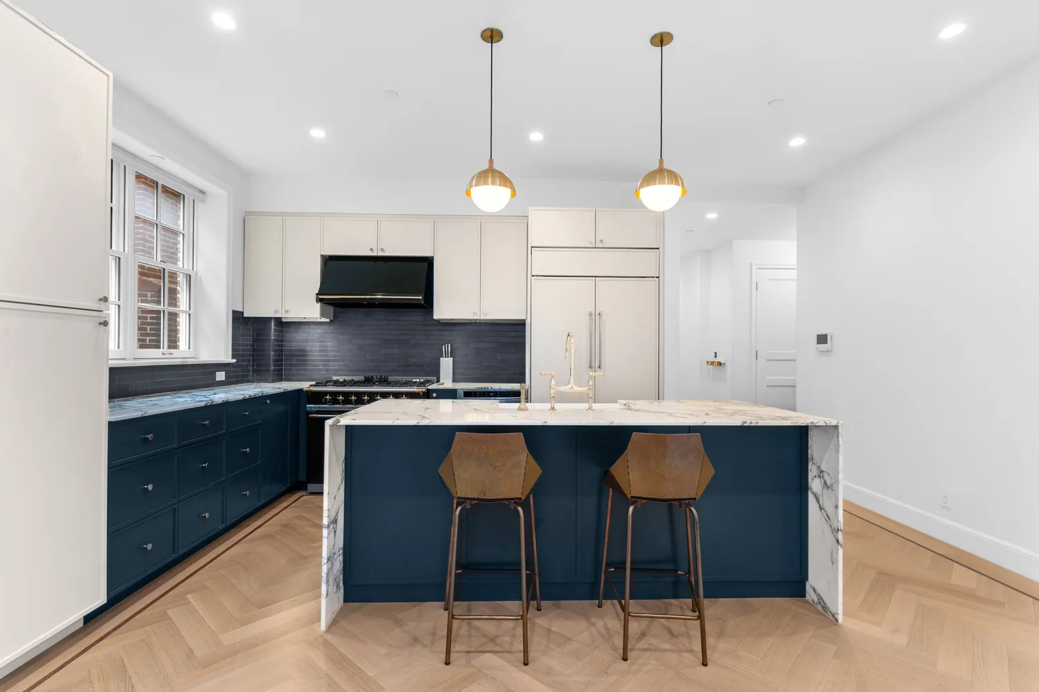 a kitchen with stainless steel appliances granite countertop a sink a stove a kitchen island and chairs with wooden floor