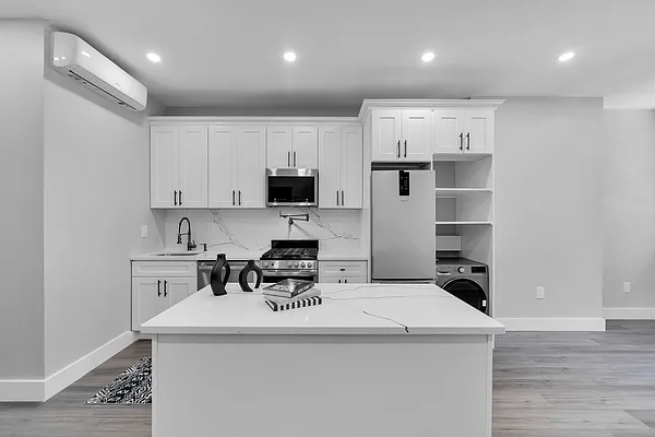 30 Marconi Place, Unit 2 Brooklyn, NY 11233 - Photo 2 of 11 a kitchen with a sink a stove a refrigerator and white cabinets