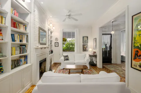 a living room with fireplace furniture and a book shelf