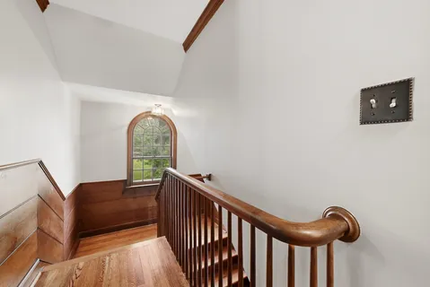 an empty room with windows and a fireplace