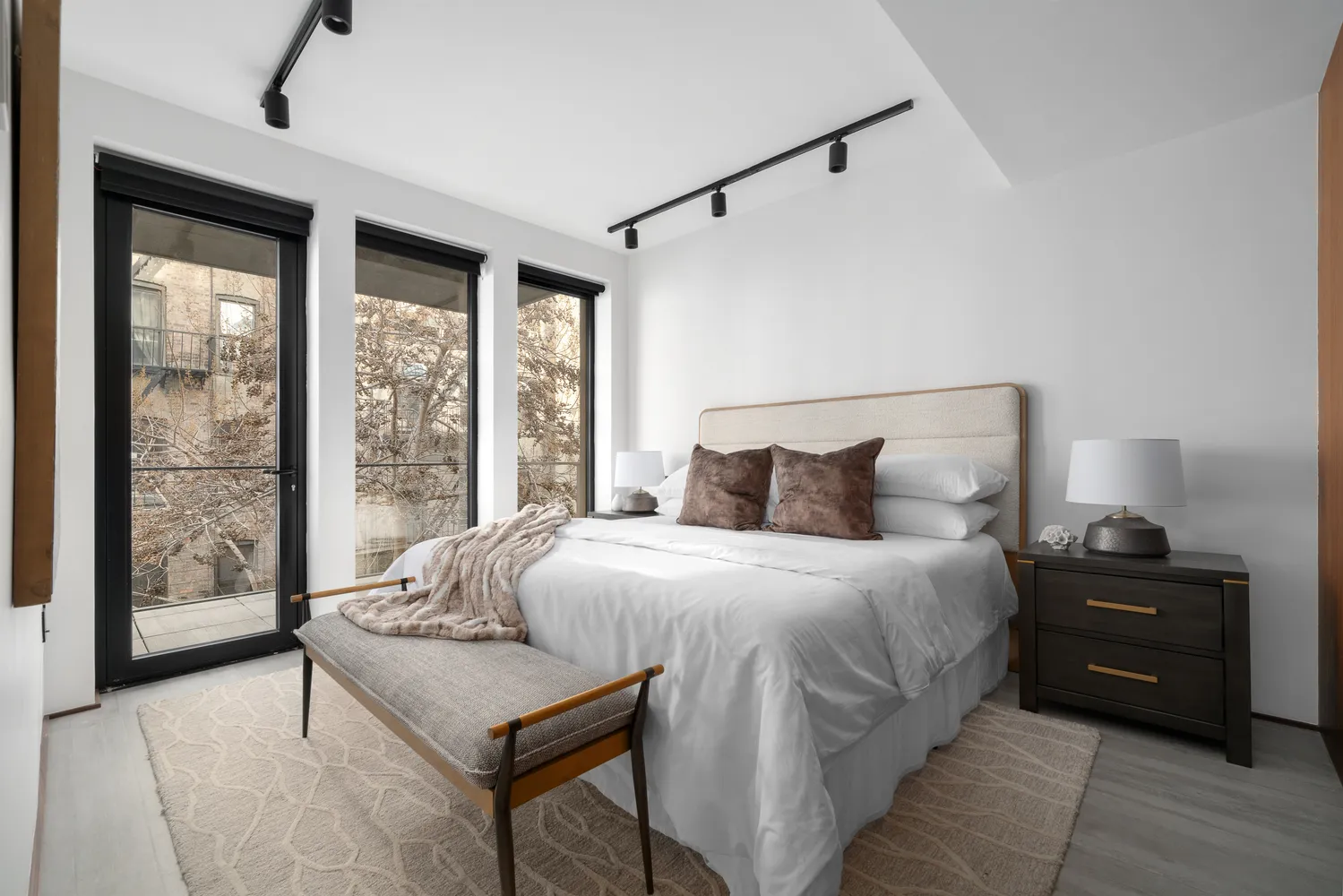 a bedroom with a bed and a large window