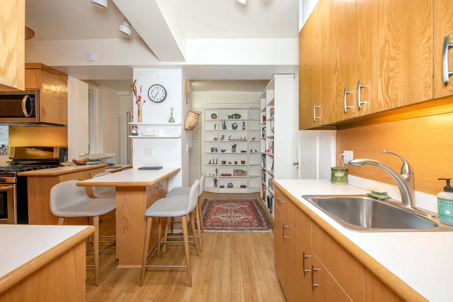 a kitchen with stainless steel appliances granite countertop a sink and a stove