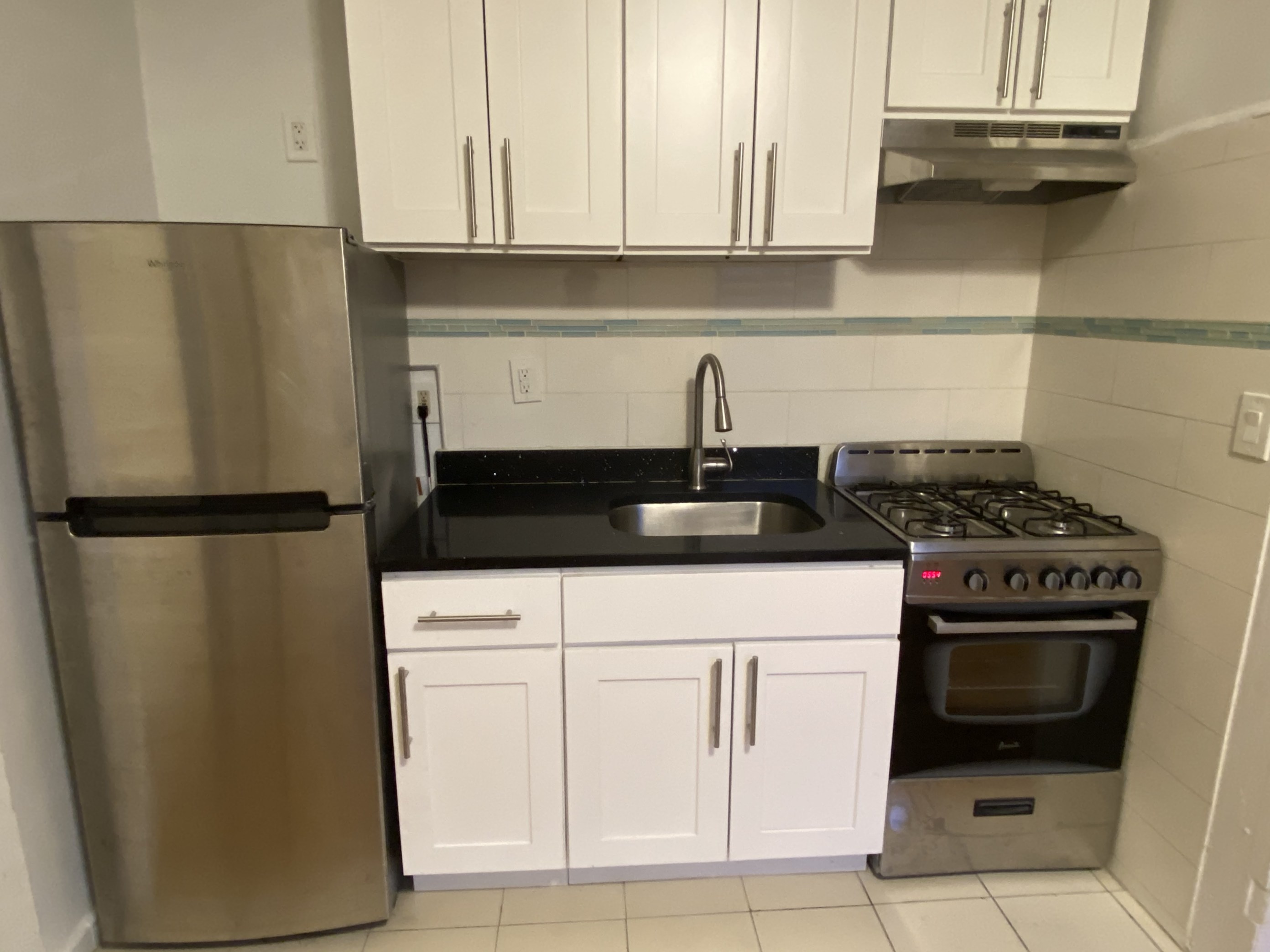 357 Sterling Place, Unit C1 Brooklyn, NY 11238 - Photo 6 of 8 a kitchen with a refrigerator and cabinets