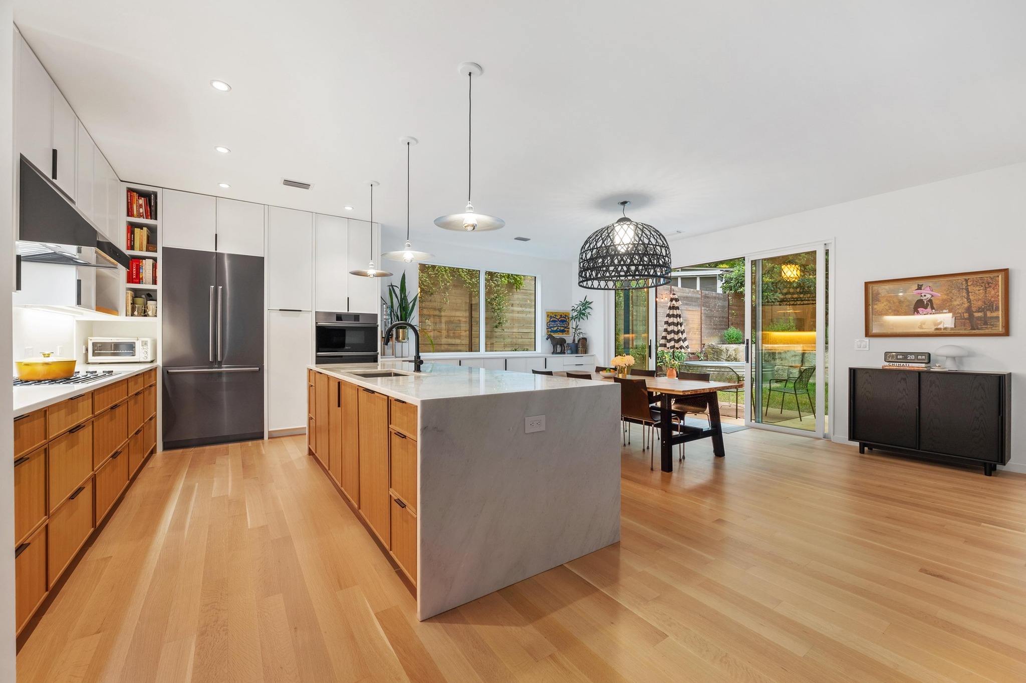 1206 Bickler Road Austin, TX 78704 - Photo 24 of 65 a kitchen with stainless steel appliances a refrigerator a stove a sink dishwasher a oven with a dining table and chairs
