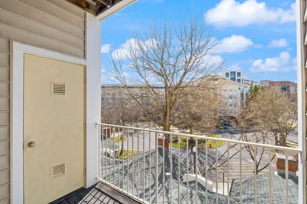 a view of balcony with wooden floor and fence