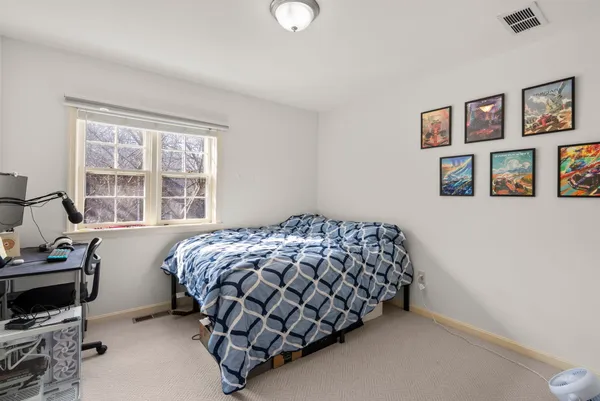 a bedroom with bed and a window