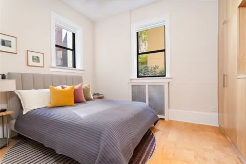 a bedroom with a bed and wooden floor