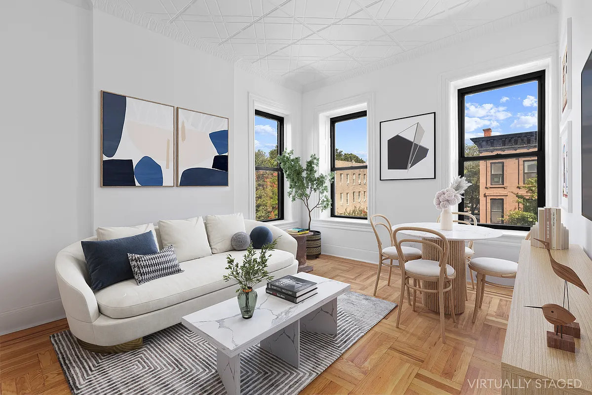 a living room with furniture and a painting on the wall
