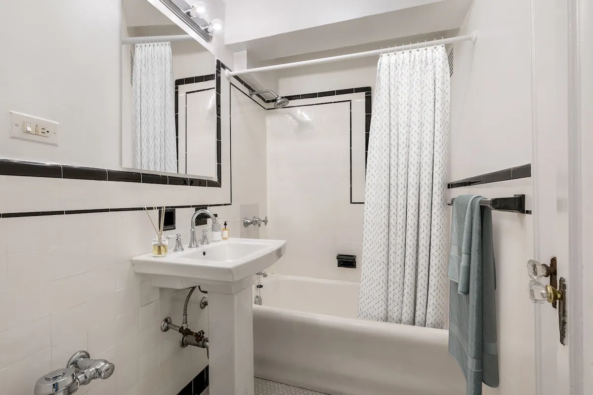 a bathroom with a sink mirror shower and toilet