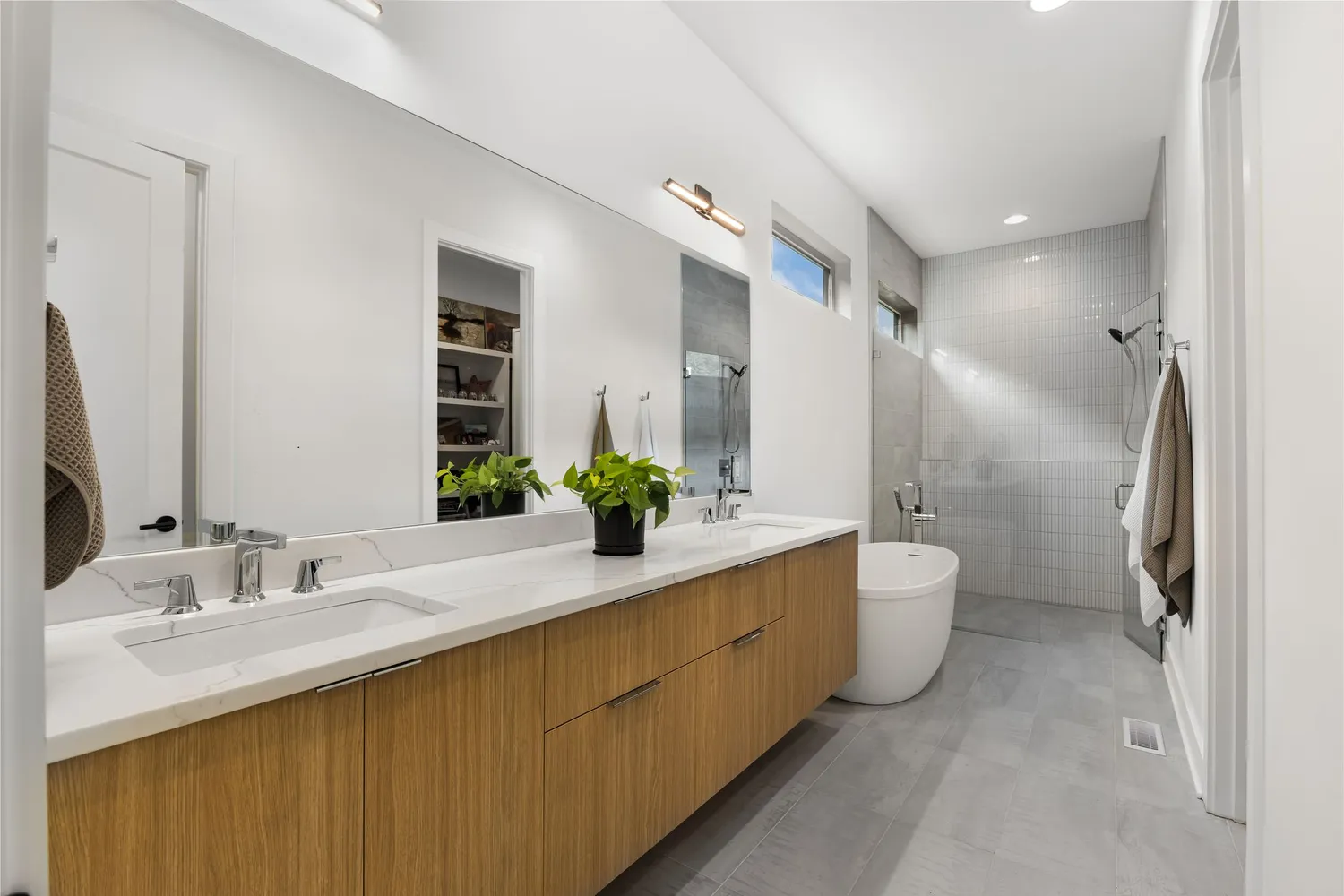 a bathroom with a double vanity sink toilet and shower