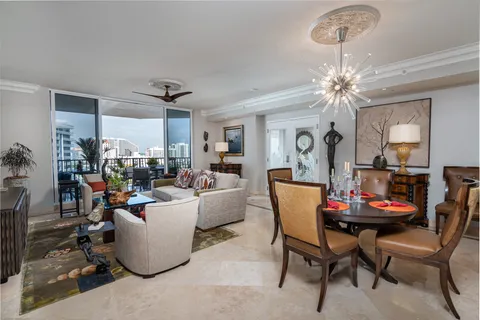 a living room with furniture a chandelier and a dining room