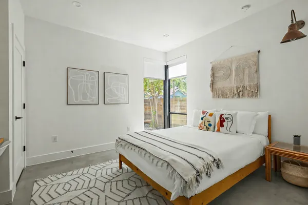 a bedroom with a bed and a window