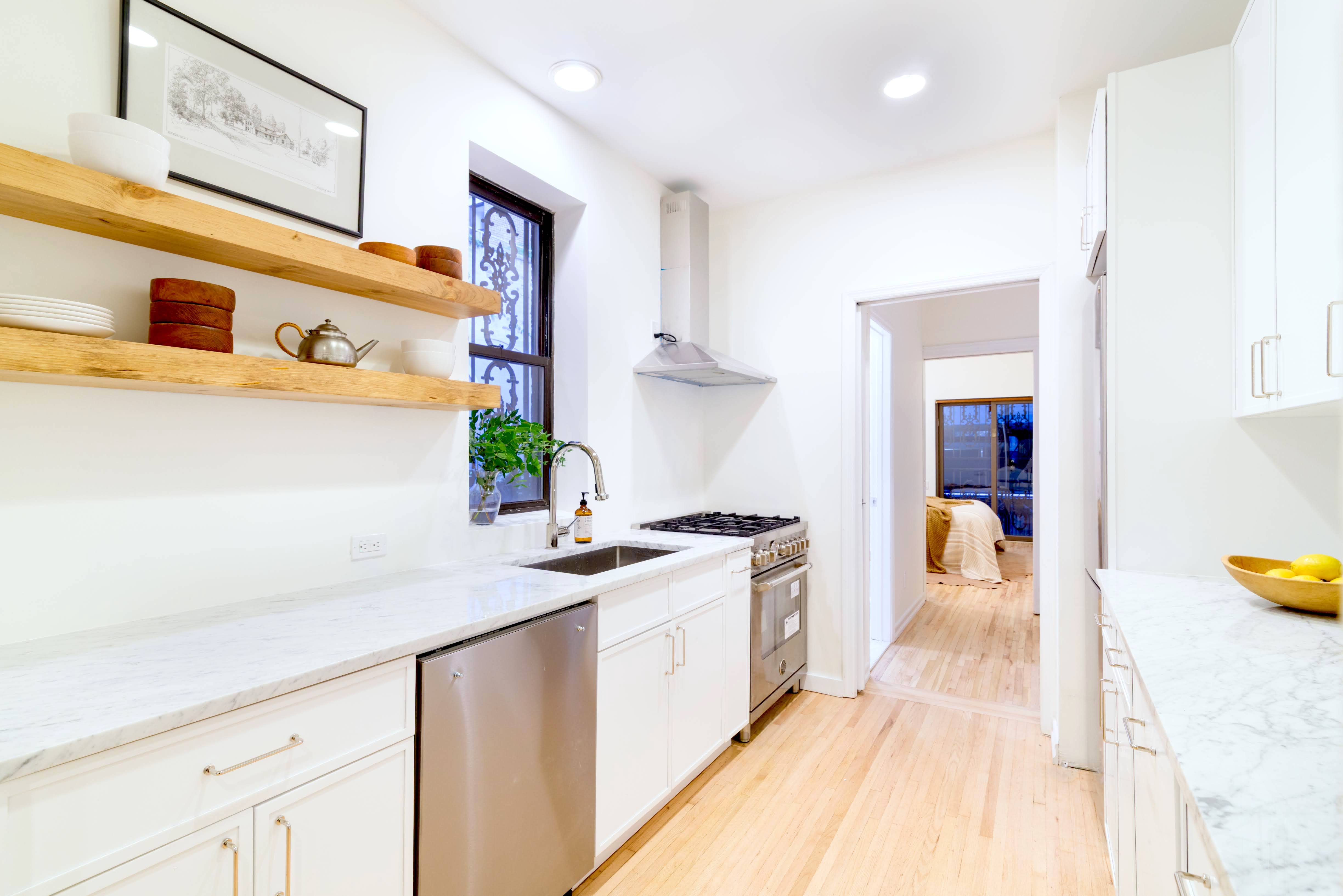 349 West 71st Street Manhattan, NY 10023 - Photo 6 of 21 a kitchen with stainless steel appliances granite countertop a sink and a stove