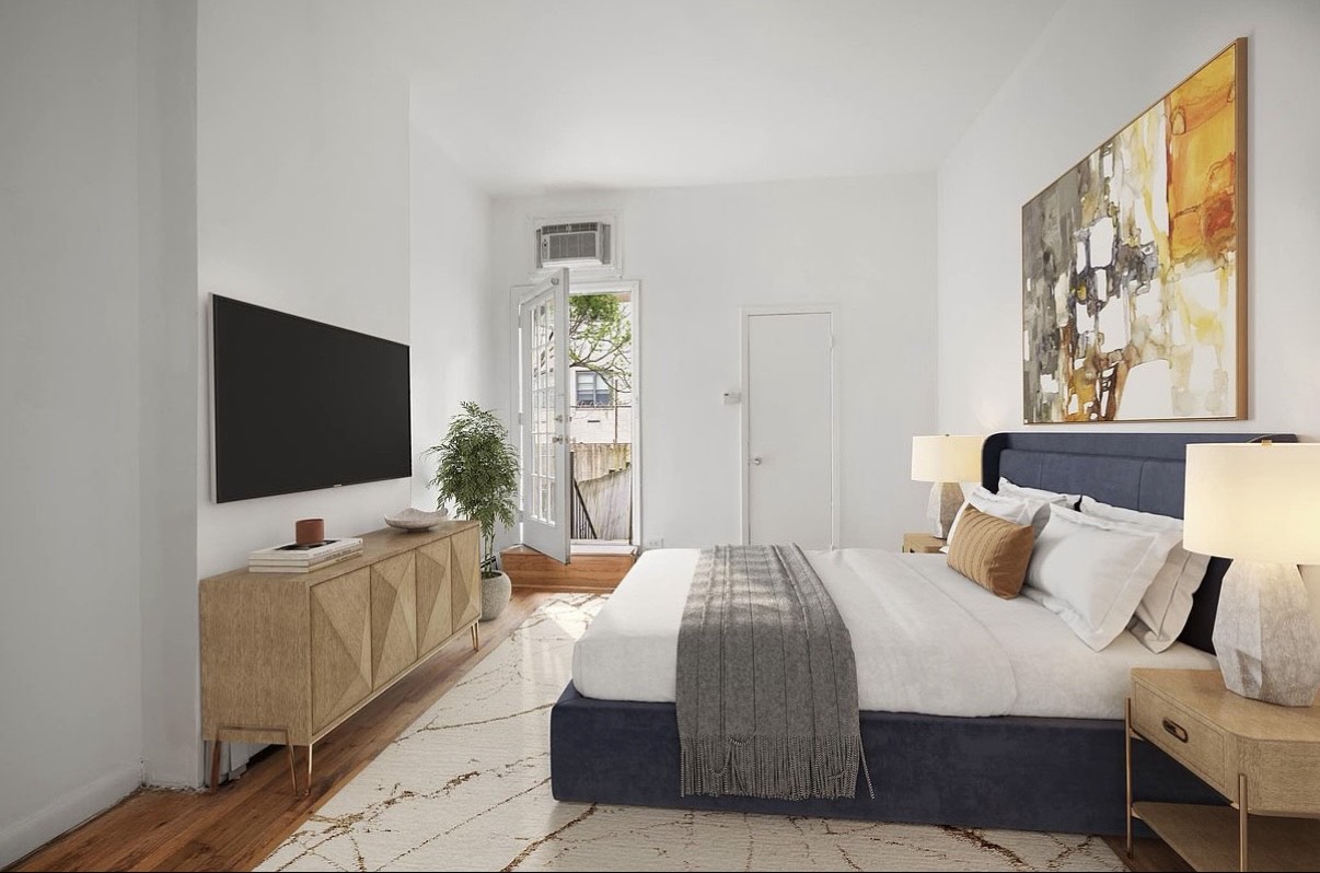 103 West 105th Street, Unit 1B Manhattan, NY 10025 - Photo 4 of 6 a bedroom with a bed and a flat screen tv