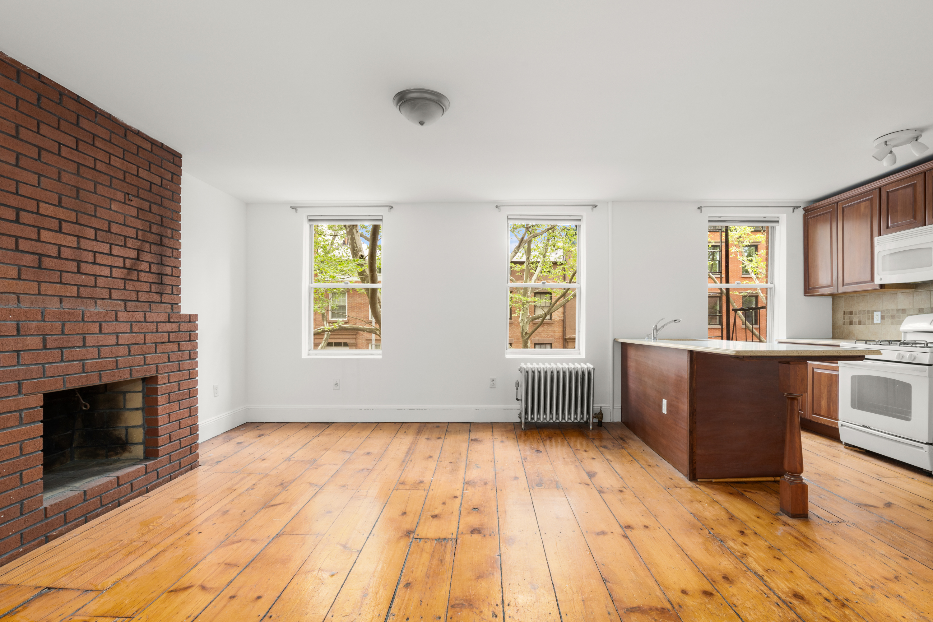 38 Douglass Street Brooklyn, NY 11231 - Photo 14 of 20 a view of empty room with kitchen and fireplace