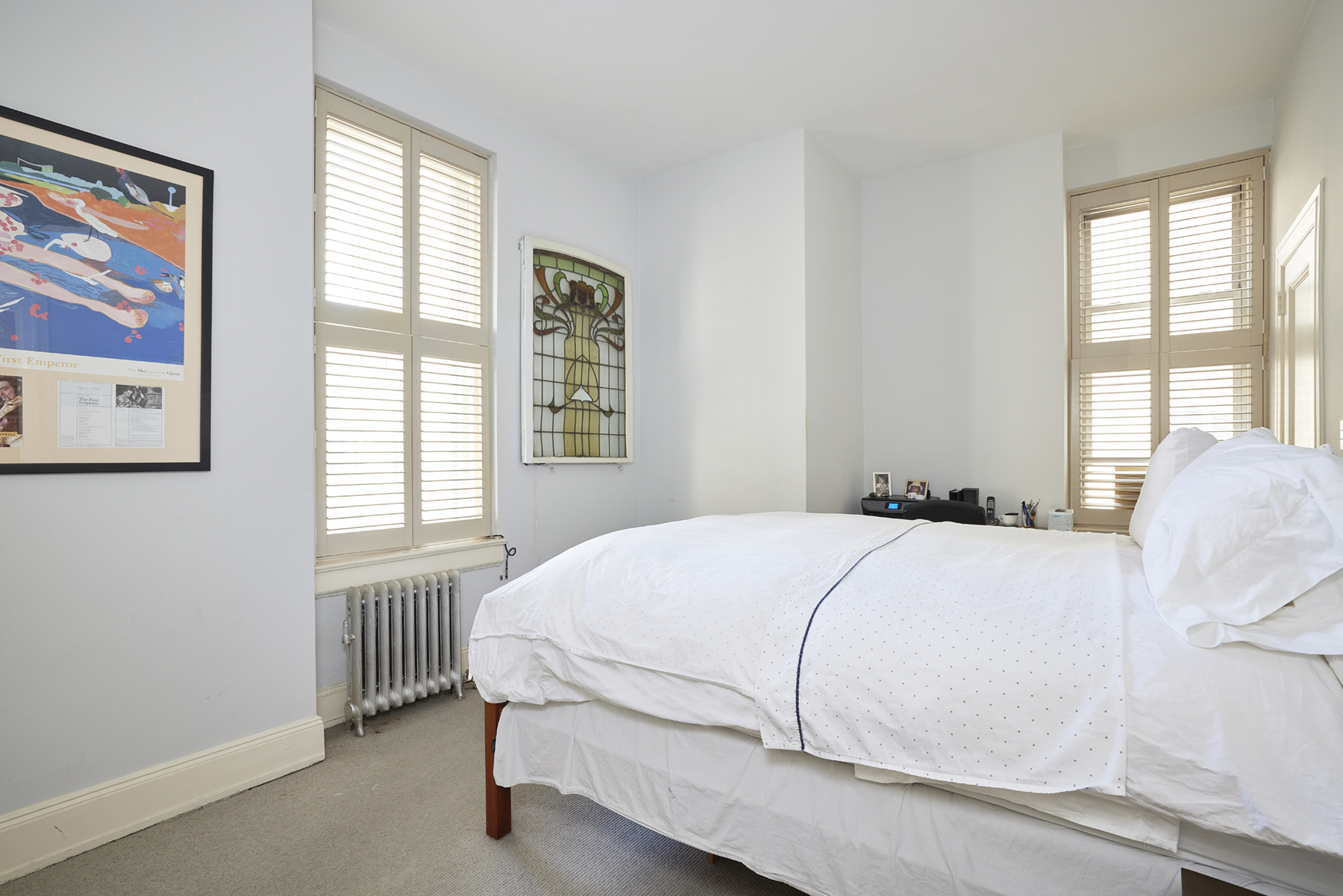 907 5th Avenue, Unit 4F Manhattan, NY 10021 - Photo 6 of 13 a bedroom with a bed and a window