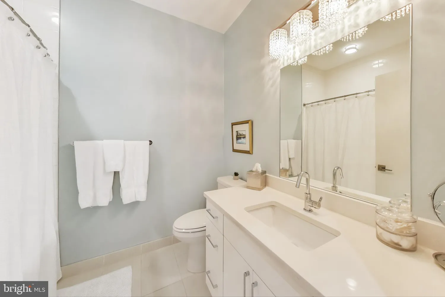 a bathroom with a double vanity sink mirror and toilet
