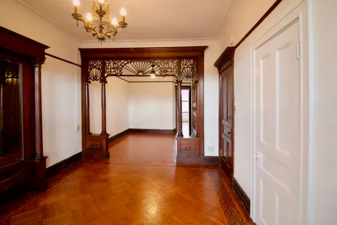 a view of a hallway with a dining room