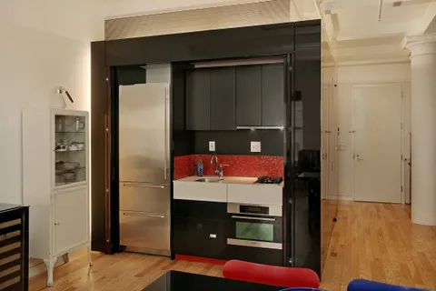 a kitchen with a refrigerator and a stove
