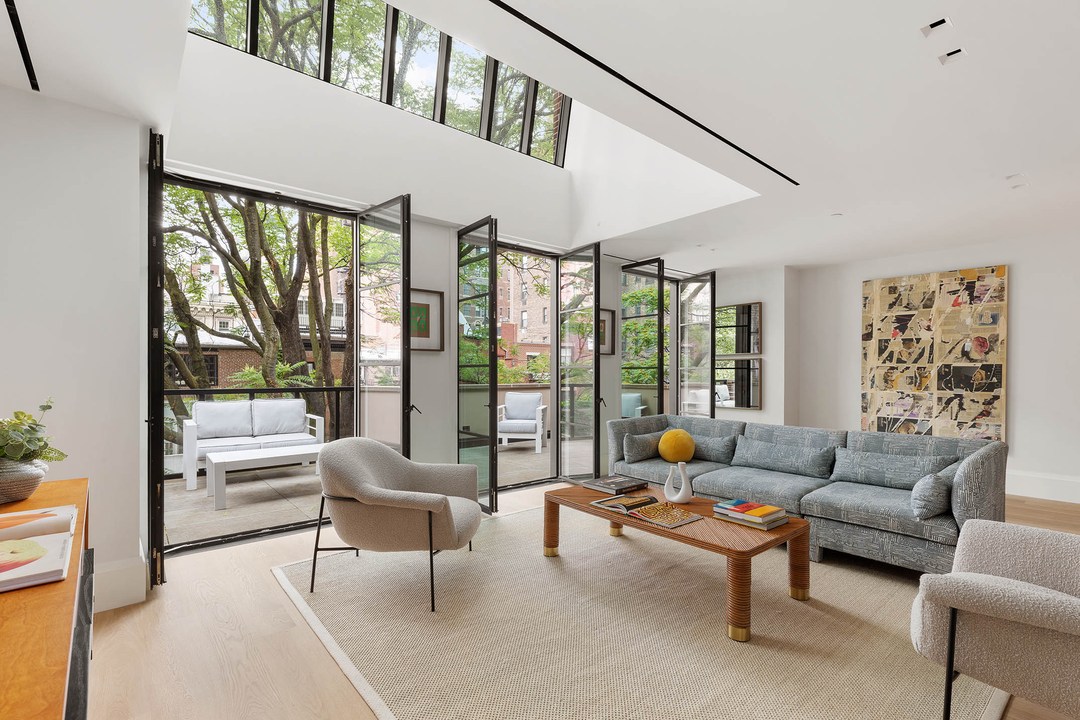 17 East 9th Street Manhattan, NY 10003 - Photo 23 of 32 a living room with furniture and a large window