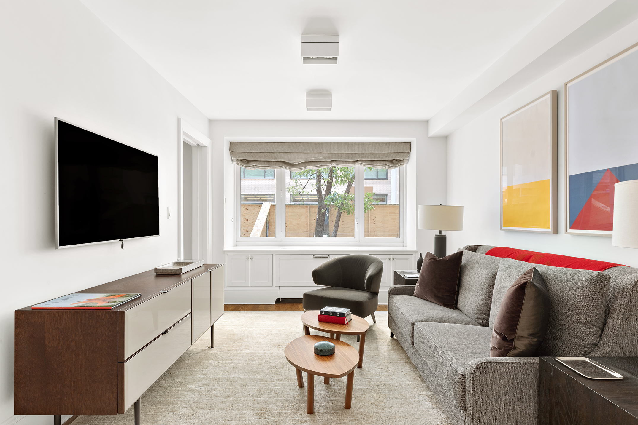 530 Park Avenue, Unit 2F Manhattan, NY 10065 - Photo 13 of 19 a living room with furniture and a flat screen tv